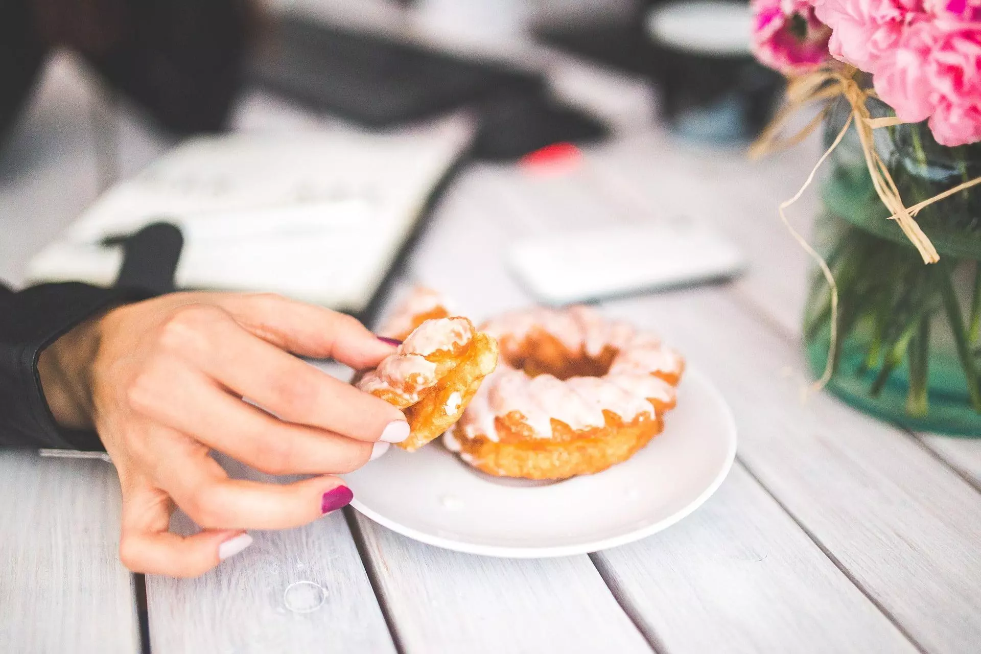 woman eating donut after exercise