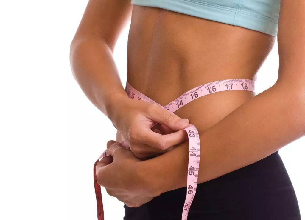 woman with measuring tape around her waist