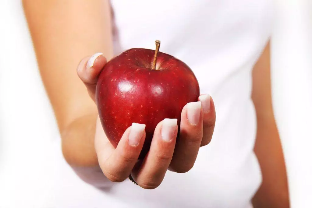 woman holding an apple