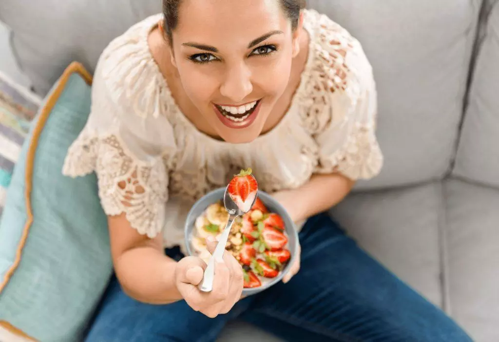 woman eating happily