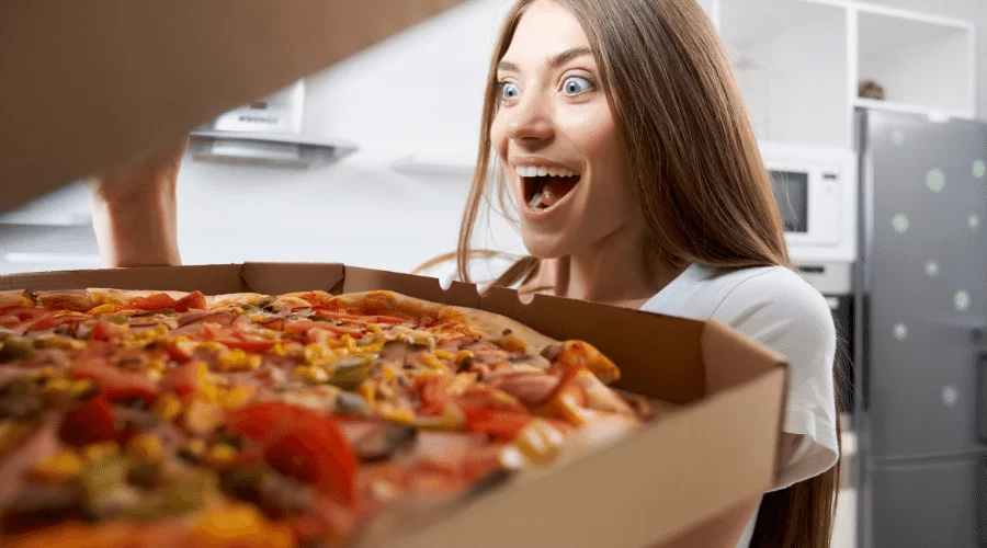 woman eating pizza